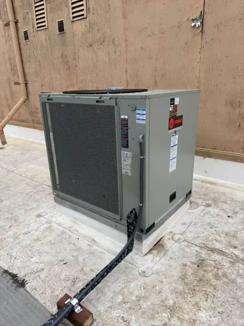HVAC technician performing AC repair on outdoor unit